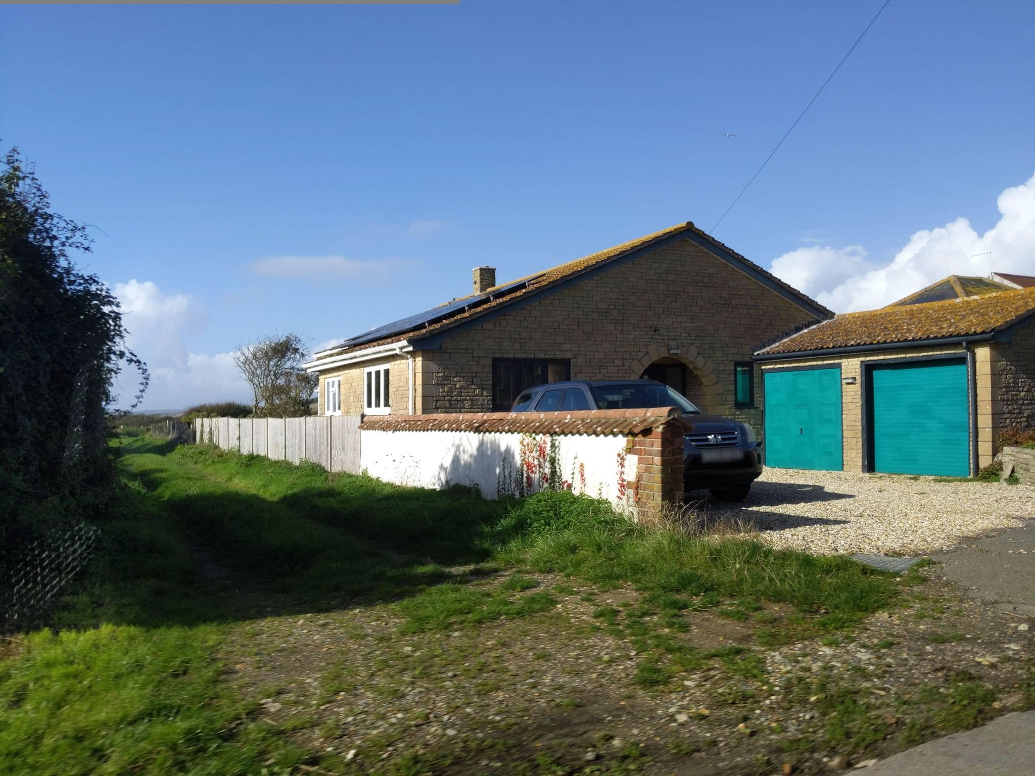 Street view near Tamarisk Farm Holiday Cottages, West Bay — © WaggyDog (CC BY-SA · Mapillary)