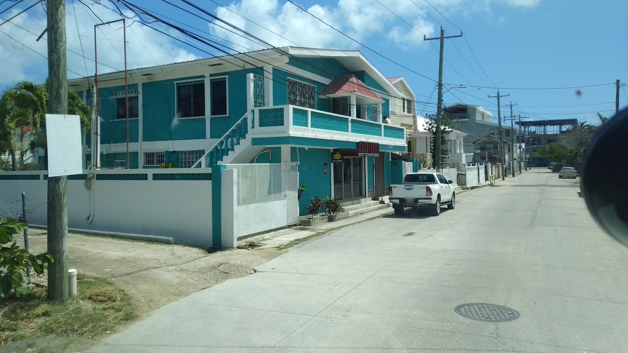 Street view near Sir Angel’s Guest House, Belize City — © charlieplett (CC BY-SA · Mapillary)